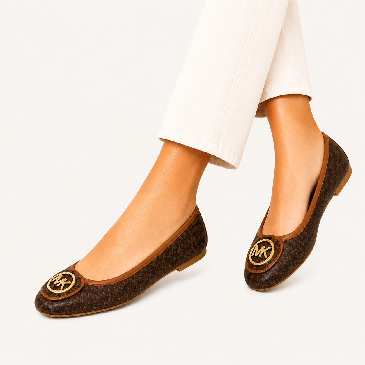 Michael Kors Lillie loafers with logo in brown with gold details.