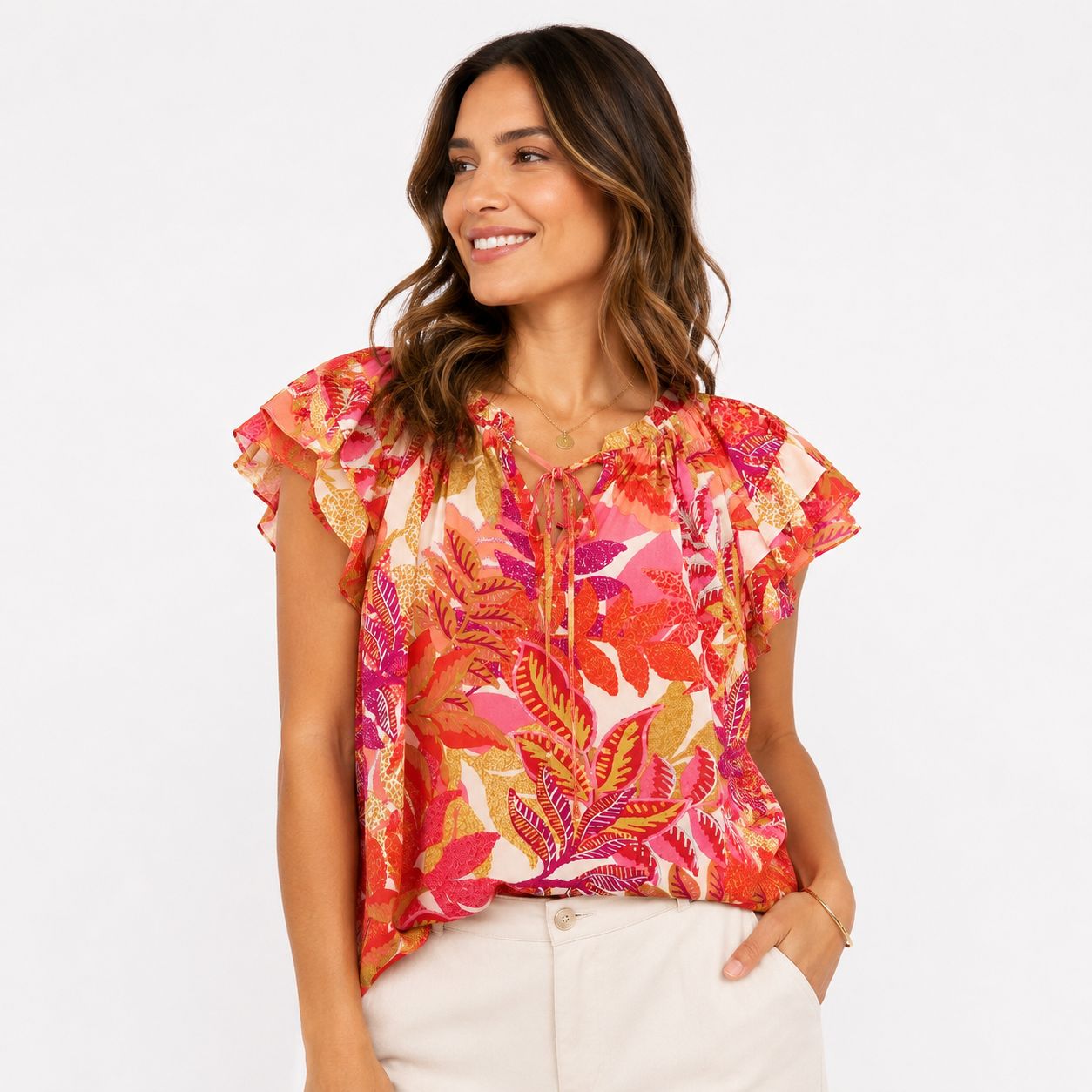 A Rose & Olive blouse with tropical leaf print in orange, fuchsia and yellow tones